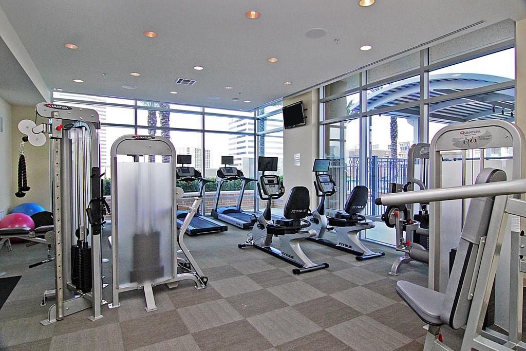 Highland Tower Fitness Center with premium equipment and floor-to-ceiling windows