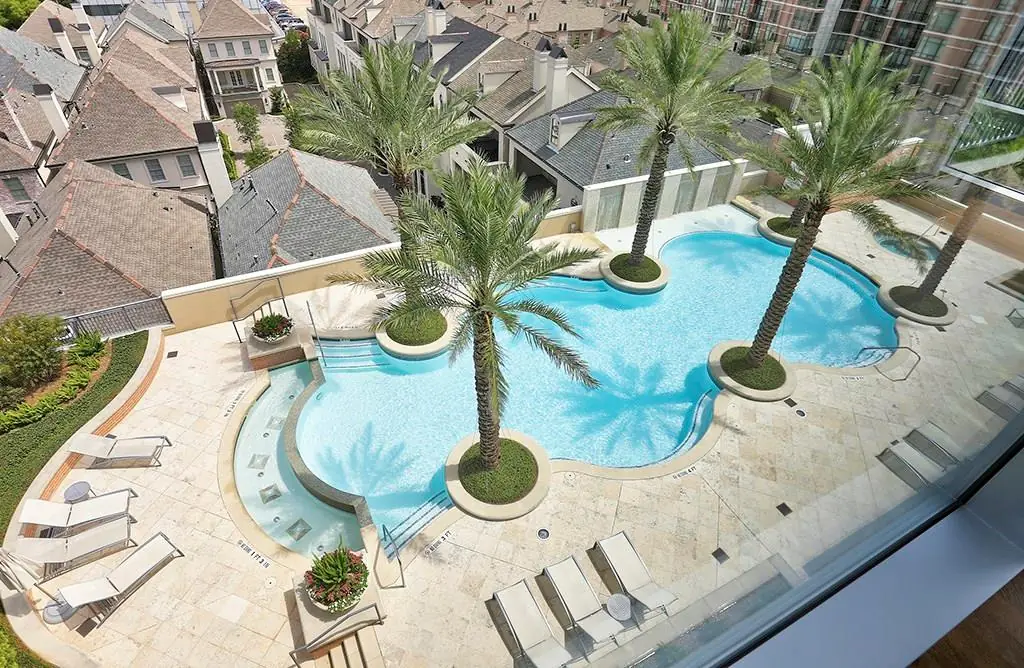 Highland Tower resort-style pool with palm trees and city views